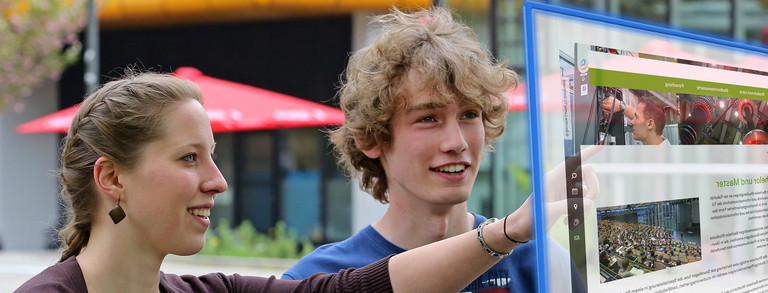 Two students in front of a projection Two students in front of a projection